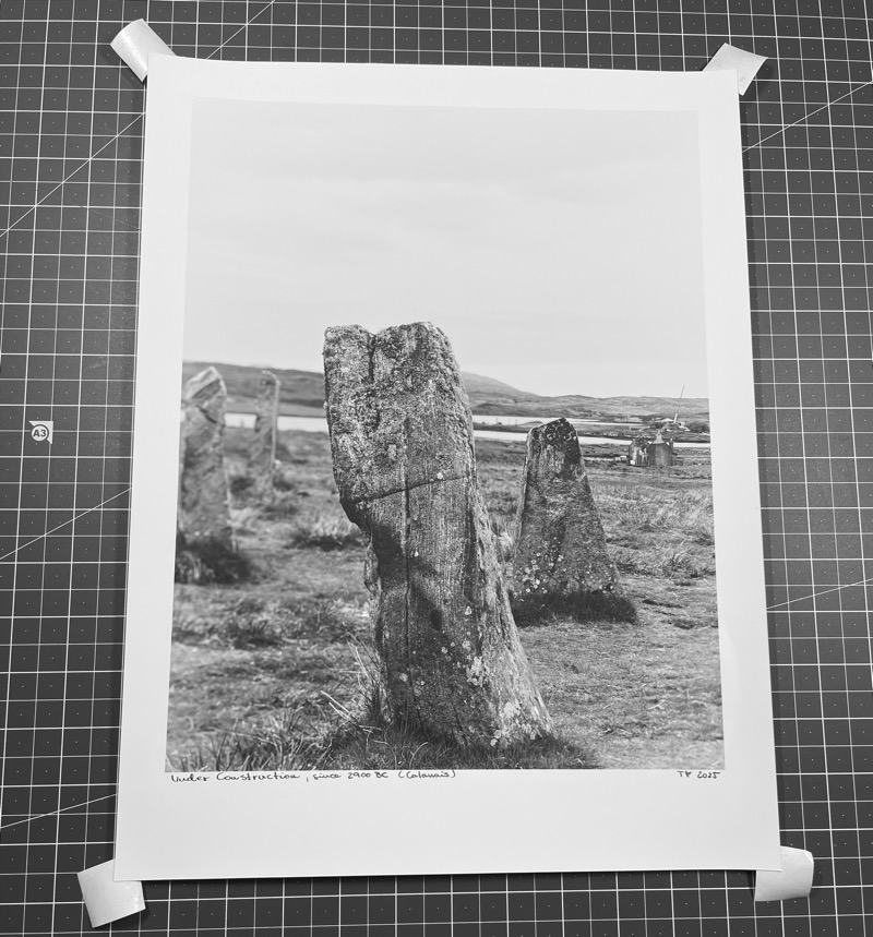 four bits of tape attached to coreners of print